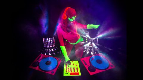 4k sexy female DJ mixes in a club in UV fluorescent costume. stylish,  cool and unique clip for events, parties and shows