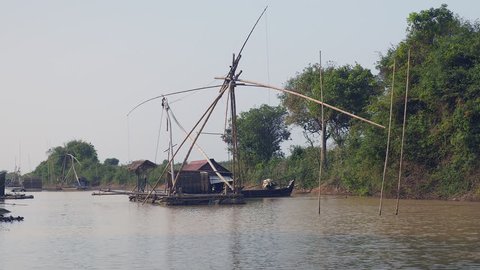  House boat with chinese fishing net at low tide