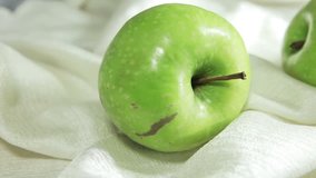 Video overview of green apple. Fruit Still Life in a white box.