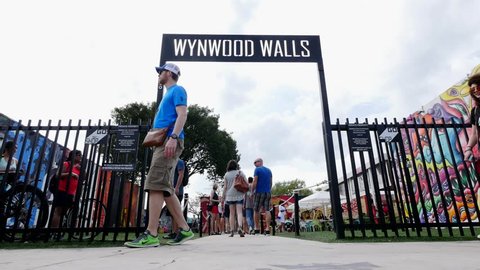 MIAMI, USA - MARCH 19, 2016: Wynwood Wall entrance with people. The Wynwood Art District Association was founded in early 2003 by a group of art dealers, artists and curators.