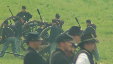 GETTYSBURG, PENNSYLVANIA - JULY 2008 - large-scale, epic Civil War anniversary reenactment -- in the middle of battle.  Union Cannon and Artillery soldiers firing and fighting, cannons and smoke. boom