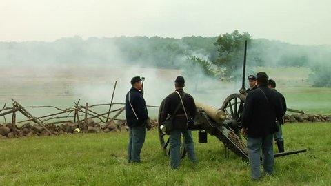 GETTYSBURG, PENNSYLVANIA - JULY 2008 - large-scale, epic Civil War anniversary reenactment -- in the middle of battle.  Union Cannon and Artillery soldiers firing and fighting, cannons and smoke. boom