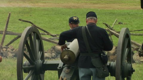 GETTYSBURG, PENNSYLVANIA - JULY 2008 - large-scale, epic Civil War anniversary reenactment -- in the middle of battle.  Re-enactor Union Cannon artillery soldiers firing and fighting cannons and smoke