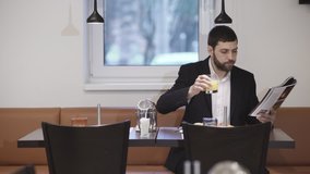 Businessman reading magazine during breakfast. UHD 4K - Powered by Shutterstock - Get 15% off with code: PIKWIZARD15