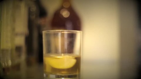 Shot of Putting Date rape drug in a drink