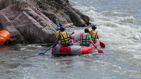 Group rafting on the turbulent mountain river.