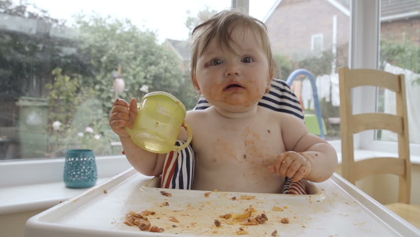 baby eating in high chair