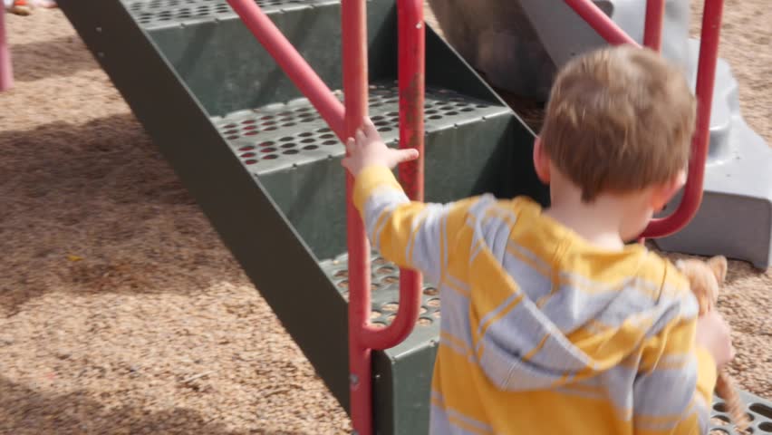 A gimbal shot of a family playing at a park with their kids