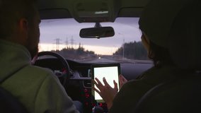 two people riding in the car and discuss the route in tablet with map. Shoot with RED EPIC. - Powered by Shutterstock - Get 15% off with code: PIKWIZARD15