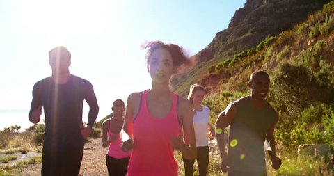 Group of multi-ethnic friends doing a running training outdoors on a footpath