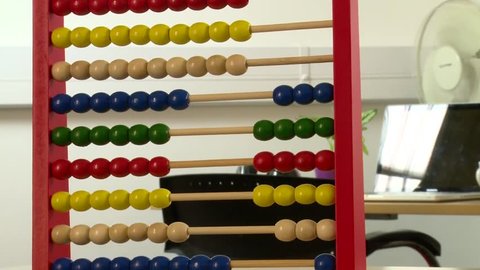 An abacus and magnifying glass show the concept of insights marketing and strategy