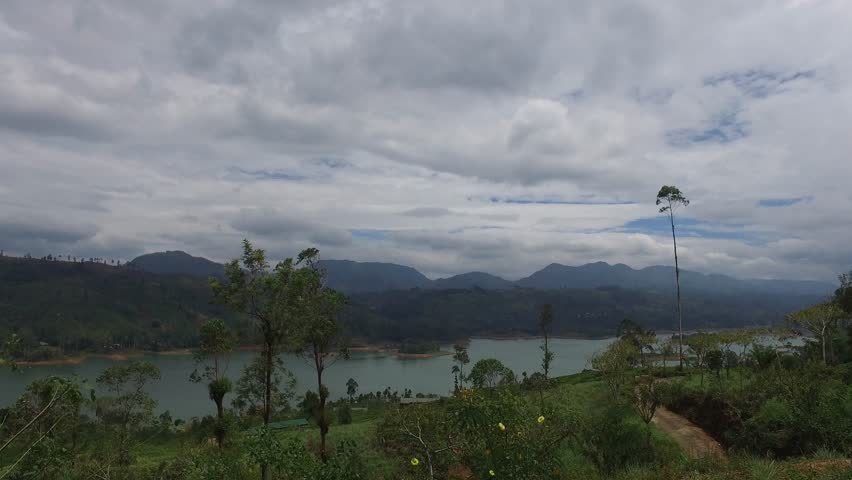 travel, tourism, vacation and summer holidays concept - view to lake or river from land hills