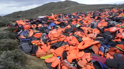 LESVOS, GREECE March 16, 2016: Mountain of Lifejackets left by refugees. These Syrian, Afghanistan and African refugees land their boat at the coast of Lesvos near Molivos, Eftalou