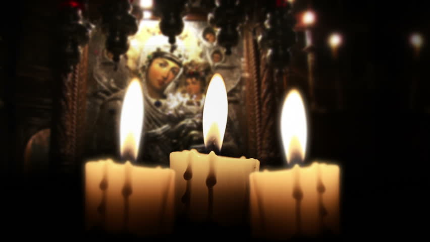 Candle in the night, close up, inside church, loop