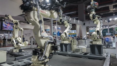 SHANGHAI, CHINA - NOVEMBER 2015: Time lapse of production robots assembling cars at a modern technology trade show in Shanghai, China