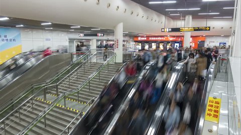 SHANGHAI, CHINA - NOVEMBER 2015: Time lapse of subway passengers descending on an escalator in a busy metro station in Shanghai, China