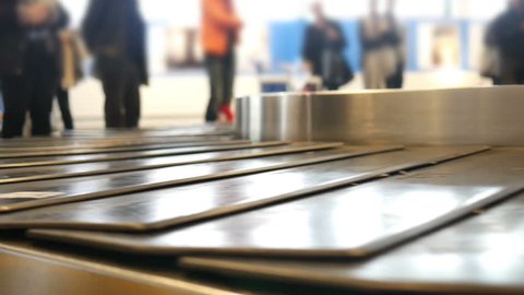 Airport baggage claim with luggage spinning around conveyor
