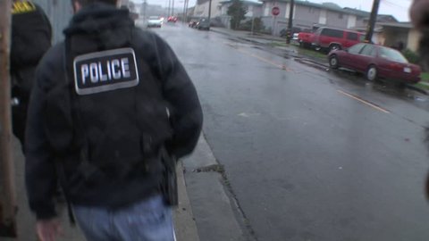 SAN FRANCISCO, CA - CIRCA 2009: A SWAT team of DEA agents raid a crack house circa 2009 in San Francisco.