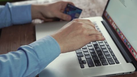 Man using credit card and computer for online shoping concept