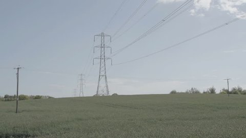 A shot of large electricity pylons in the British countryside on a summers day