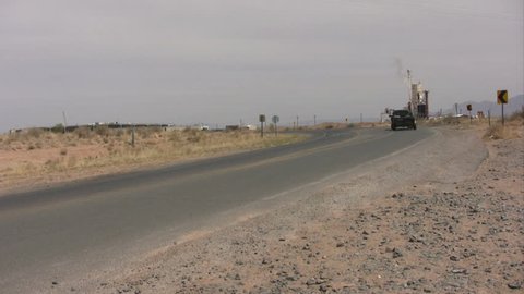 A truck with a trailer traveling away.