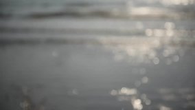 Footage : Sparkling Sea waving surface on the beach, slow motion, abstract blurry background.