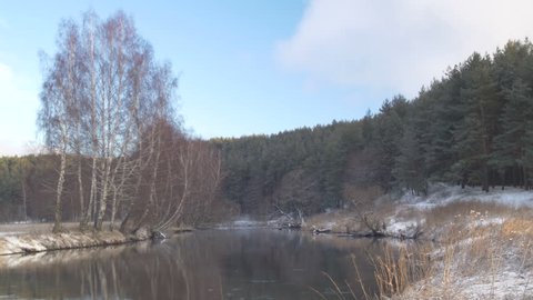 Winter landscape with river and forest.