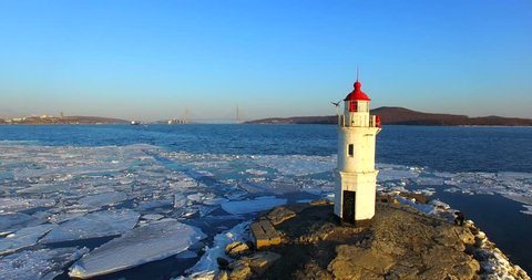 Aerial winter view of the Tokarevskiy lighthouse - one of the oldest lighthouses in the Far East, still an important navigational structure and popular attractions of Vladivostok city, Russia.