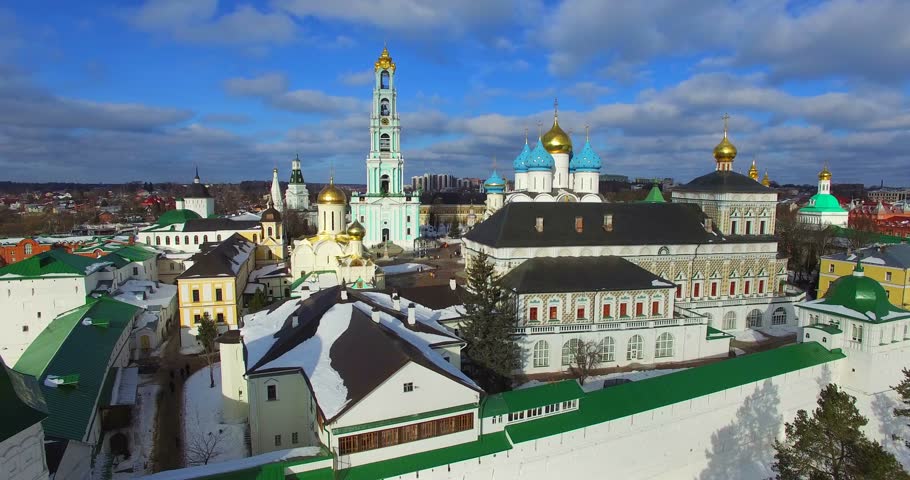 Great aerial view of the Trinity of Lavra of St. Sergius in Sergiyev Posad, flying backwards. The monastery was founded in 1345 by one of the most venerated Russian saints, Sergius of Radonezh. Winter