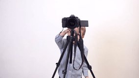 Lovely child making videos and photographs with big photo camera