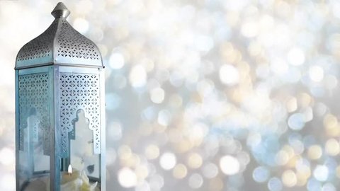 Arabic ornamental lantern with burning candle. Festive glittering bokeh lights background. Ramadan background. loopable Ramadan HD footage