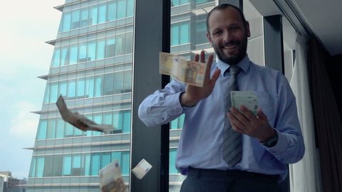 Successful, happy businessman throwing money, super slow motion 240fps
