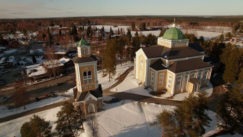 Aerial wintertime orbiting shot of the large wooden church of Kerimäki, Finland.