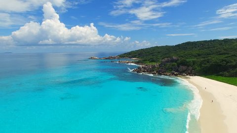 Aerial view of tropical paradise beach with white sand and turquoise crystal clear water of Indian Ocean - Grand Anse, La Digue Island, Seychelles, 4k UHD ProRes