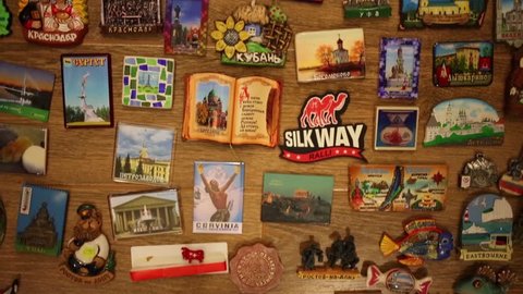 MOSCOW - FEB 10, 2015: Many refrigerator souvenir magnets on wooden floor