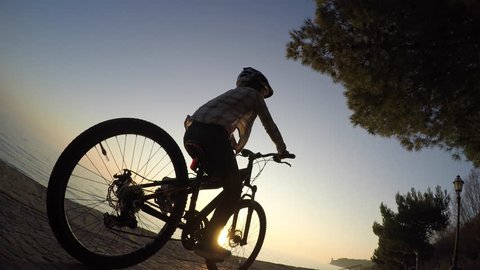 Girl cycling at sunset