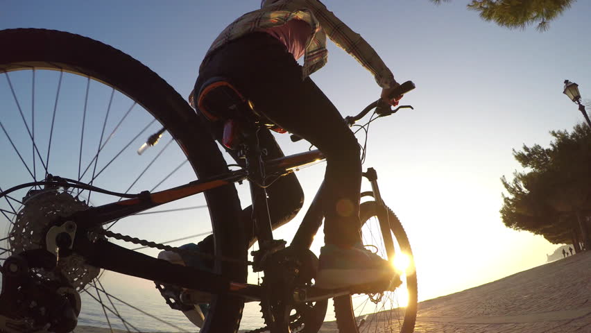 Girl riding bike at sunset Royalty-Free Stock Footage #15435091
