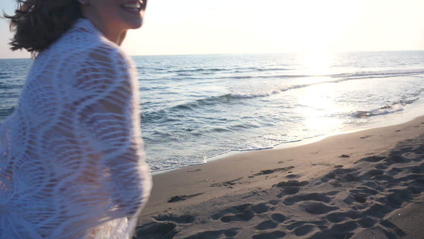beautiful young woman running on the beach 