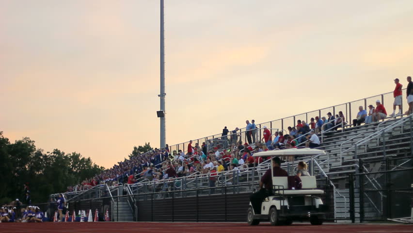 Dolly of fans in a high school stadium.