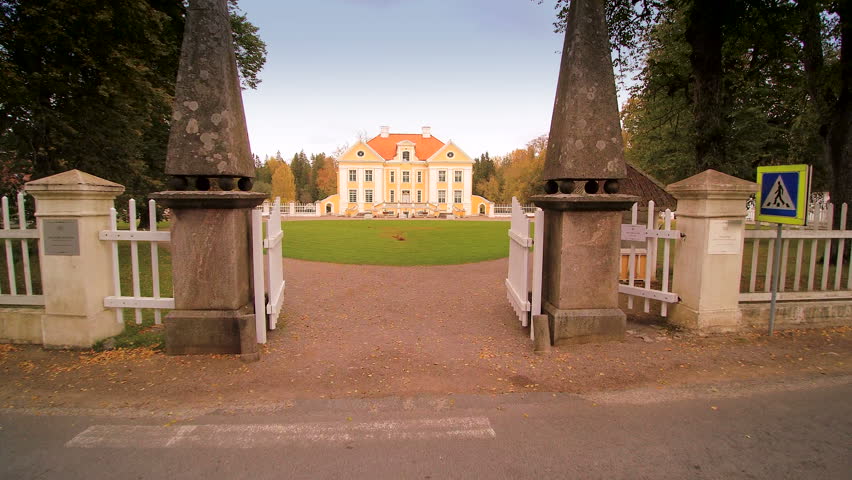 Getting inside the gate of the Palmse manor in Estonia. Taken on a fine weather where the grass in the front yard is green