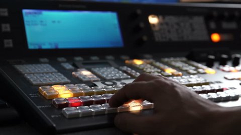The Hand of an Operator Presses Button and Mix on the Broadcasting Console