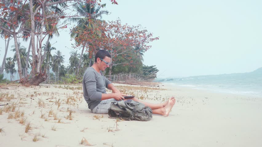 Man work on computer at the beach on the beach