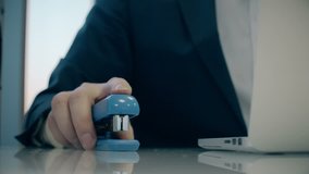 businessman uses stapler like a mouse. Office fun