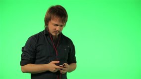 man listening to music on the phone on a green screen