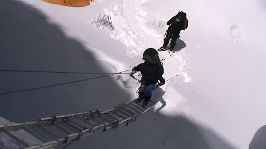 Climber climbs up ladder circa 2005 in Tibet.