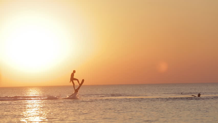 Silhouette of a Man Having Fun on Flyboard in the Sea at Sunset Royalty-Free Stock Footage #15459463