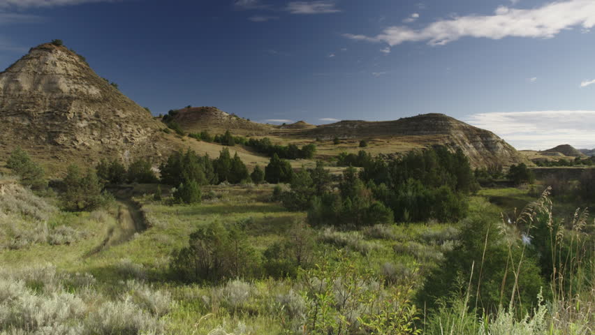 Grassy plains and peaks in the Badlands, Theodore Roosevelt National Park, North Dakota.  4K.