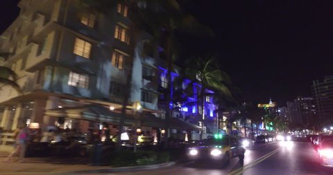 MIAMI BEACH - MARCH 22: Night motion video of Miami Beach Ocean Drive during 2016 Spring Break shot with a dji osmo on a segway March 22, 2016 in Miami Beach FL, USA