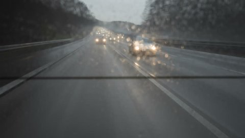 A daytime time lapse of german motorways A66 and A3 on a rainy day. unusual view through the rear window