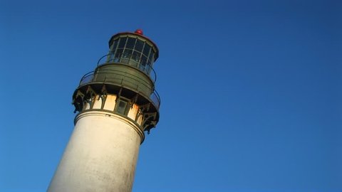 Low angle of lighthouse with sunlight on it
